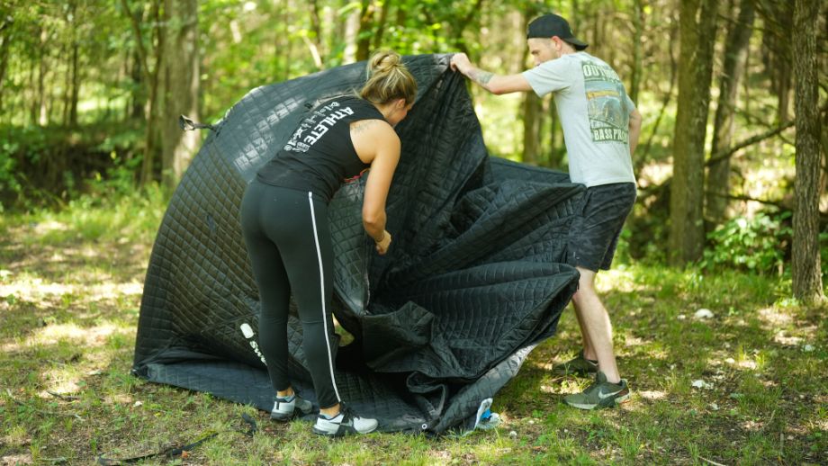 Two people opening the SweatTent