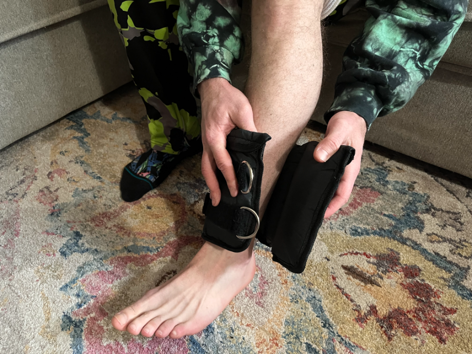 Man putting on Synergee ankle weights