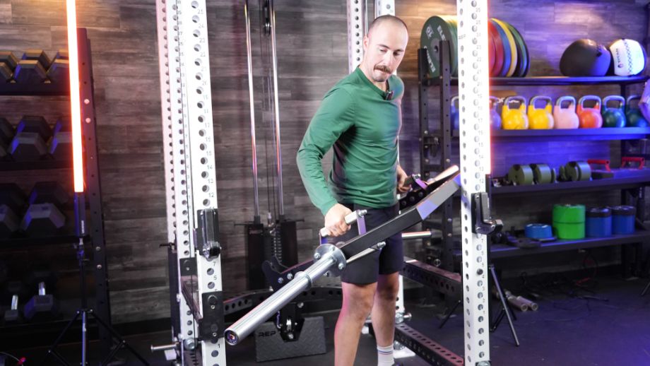 Photo of man walking the Titan Open Trap Bar into a power cage