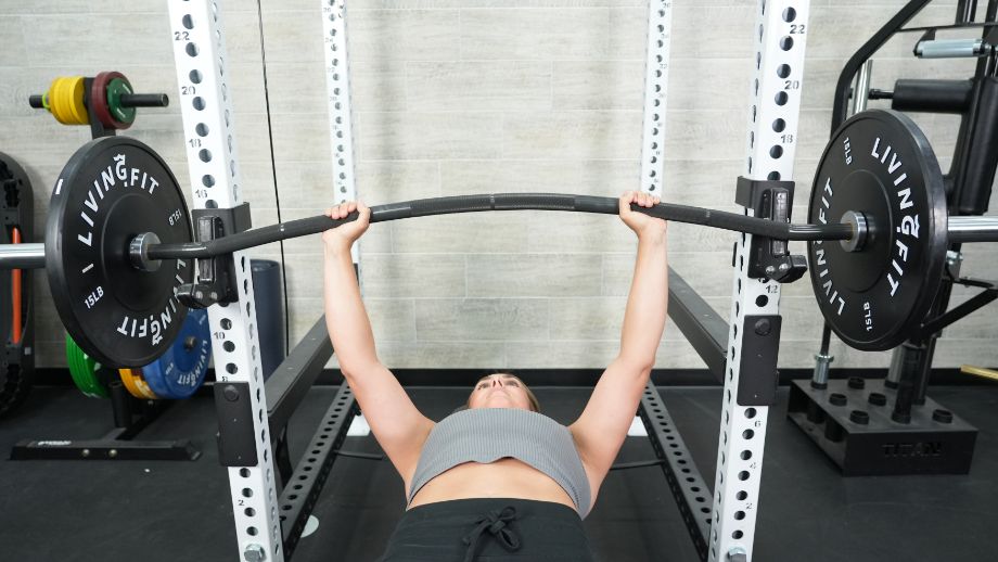 Woman benching with Vulcan Buffalo bar