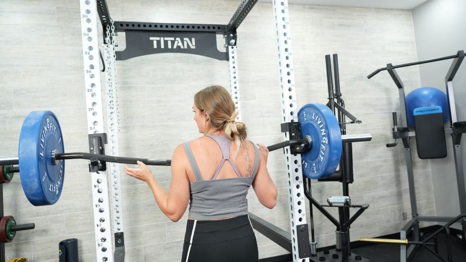 Woman rotating Vulcan Buffalo bar in squat rack