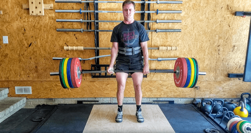 coop performing a deadlift with rogue barbell and rogue bumper plates