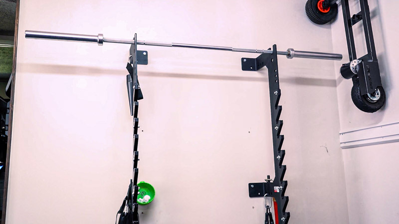 Sorinex OFF GRID Squat Rack bolted to the wall in a garage gym