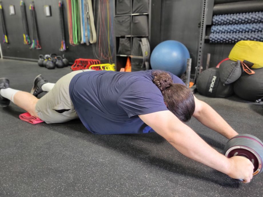 Man performing an ab rollout with the Ab Carver Pro