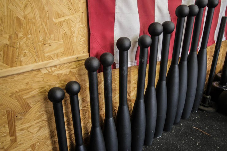 Onnit Steel Clubs in a garage gym