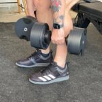 Our tester lifting weights in the adidas Powerlift 5 shoes.