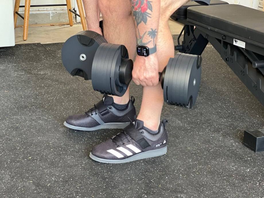 Our tester lifting weights in the adidas Powerlift 5 shoes.