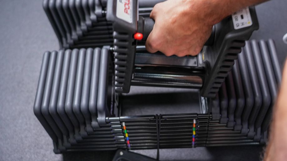 Man adjusting weights in the PowerBlock Pro 100 EXP Dumbbells