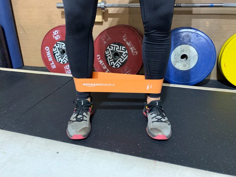 The AmazonBasics Resistance Band around a woman's ankles