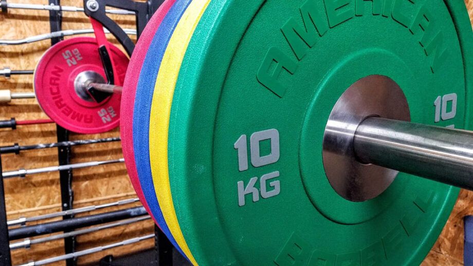 American Barbell Urethane Plates on a squat rack
