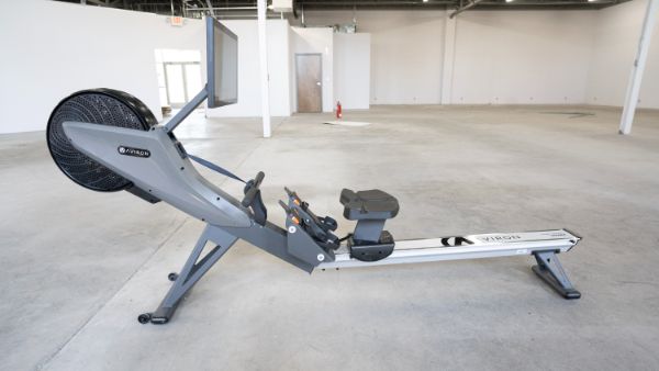 Aviron rower standing alone in a home gym.