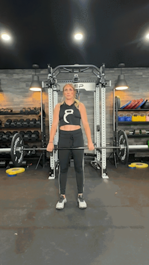 woman doing barbell shrugs