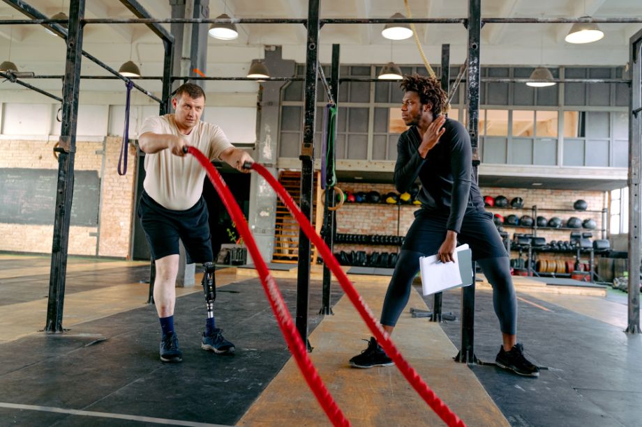 Person leading someone through a battle rope workout