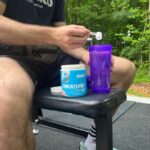 Man scooping Beast Creatine into a shaker cup