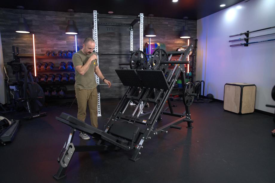 Coop stands next to the gigantic Bells of Steel Iso Leg Press and Hack Squat Machine.