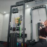 Our tester uses a wide grip on the Bells of Steel Lat Pulldown machine.