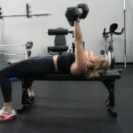 Side view of our tester doing bench presses on the Bells of Steel Flat Utility Bench.
