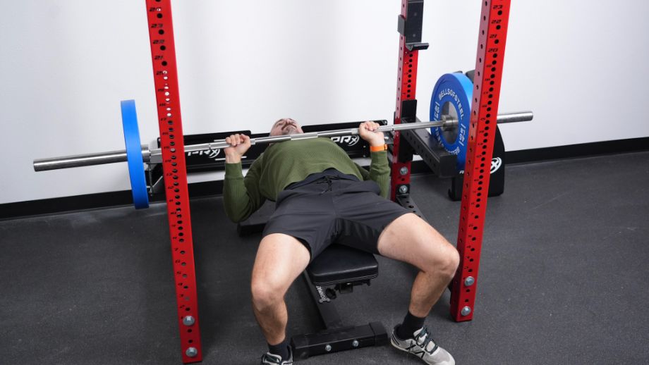 Man benching with the PRx Profile Folding Full Cage