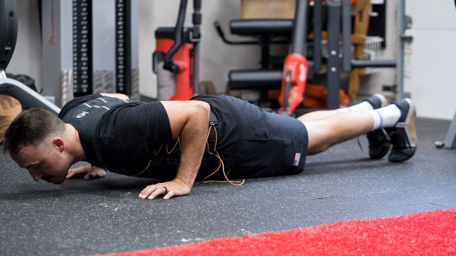 Coop doing push-ups in a home gym