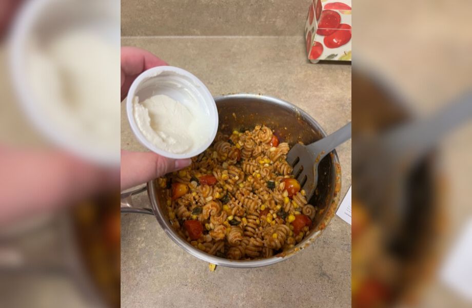 Adding and mixing sour cream into a Blue Apron meal