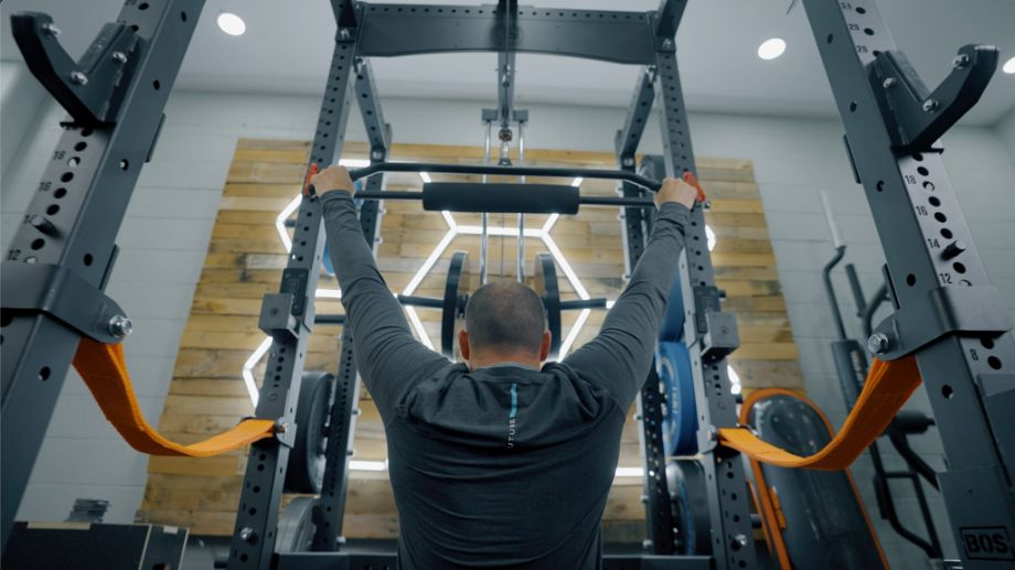 Man using lat pulldown on the Bells of Steel Hydra rack