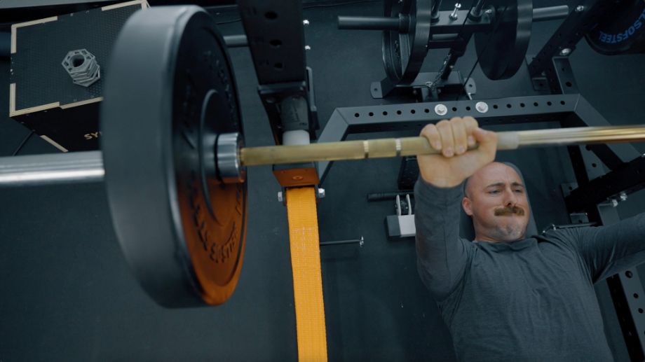 Man benching on the Bells of Steel Hydra rack