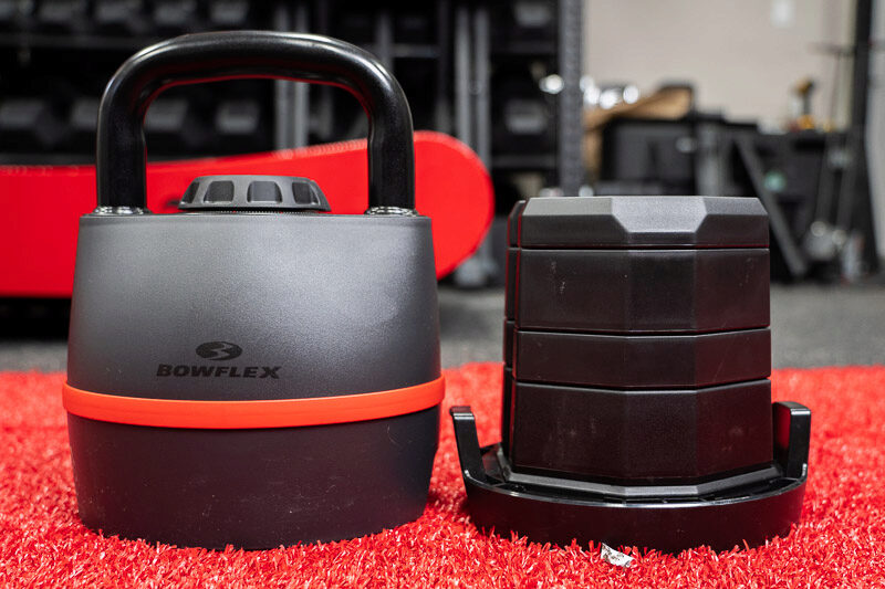 The Bowflex SelectTech Adjustable Kettlebell on the floor in a home gym