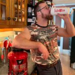Man drinking BSN True Mass out of a shaker cup