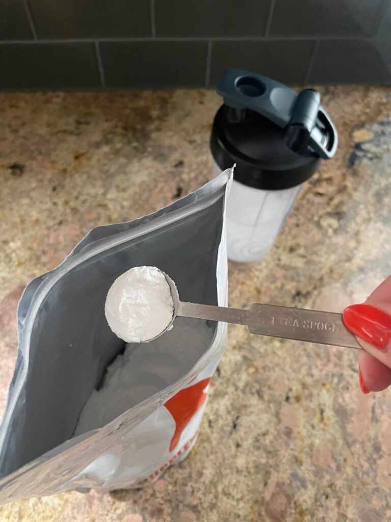 An image of BulkSupplements creatine powder bag being scooped out