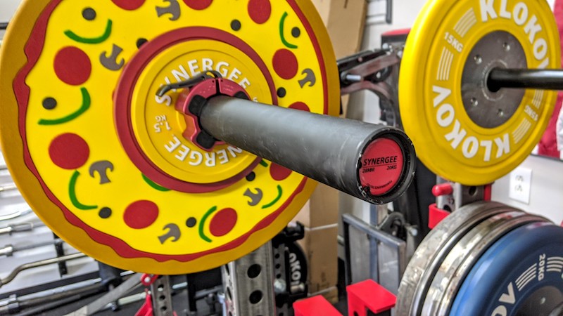 Synergee Games Cerakote Barbell in a garage gym