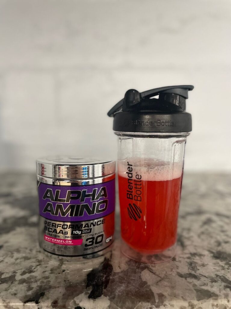 An image of Cellucor Alpha Aminos in a shaker