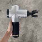Chirogun massage gun in use