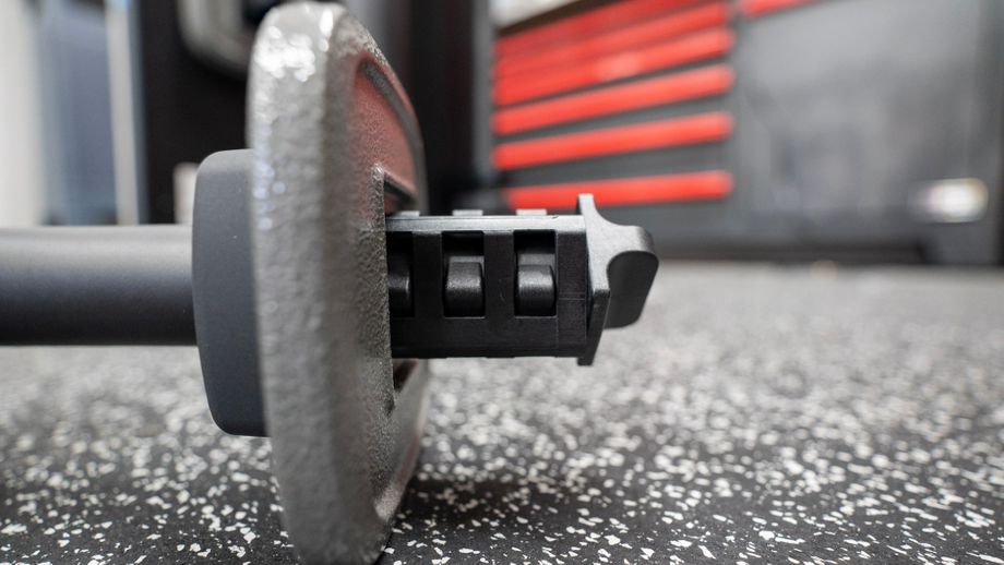 Closeup of the cast iron weight plate on the ProForm Vue dumbbell handle