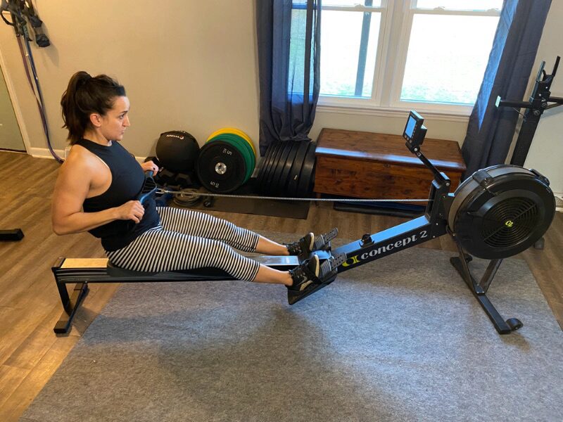 Woman using the Concept2 RowErg review in her living room