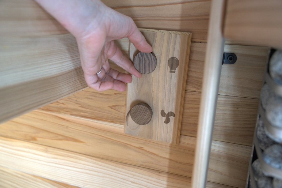 Our tester adjusts the controls in a Plunge The Sauna Mini