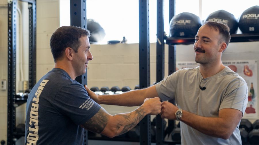 Coop and Capt. Robert Cefoli of the FDNY doing fist bumps