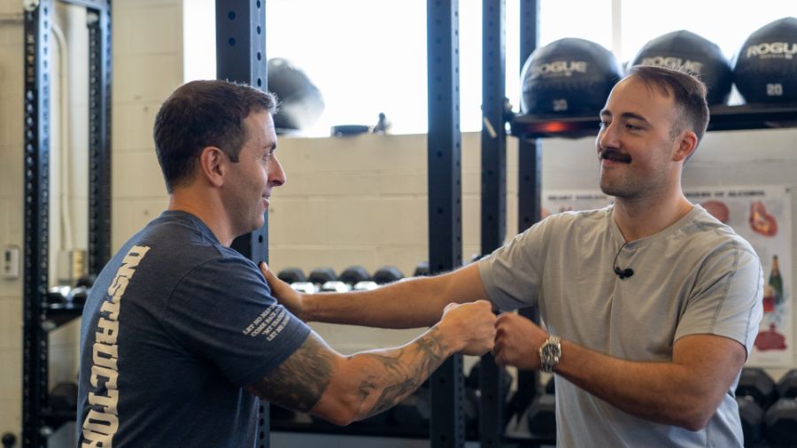 Coop and  Capt. Robert Cefoli of the FDNY doing fist bumps