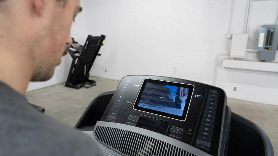 coop looking down at screen on nordictrack commercial 1750 treadmill