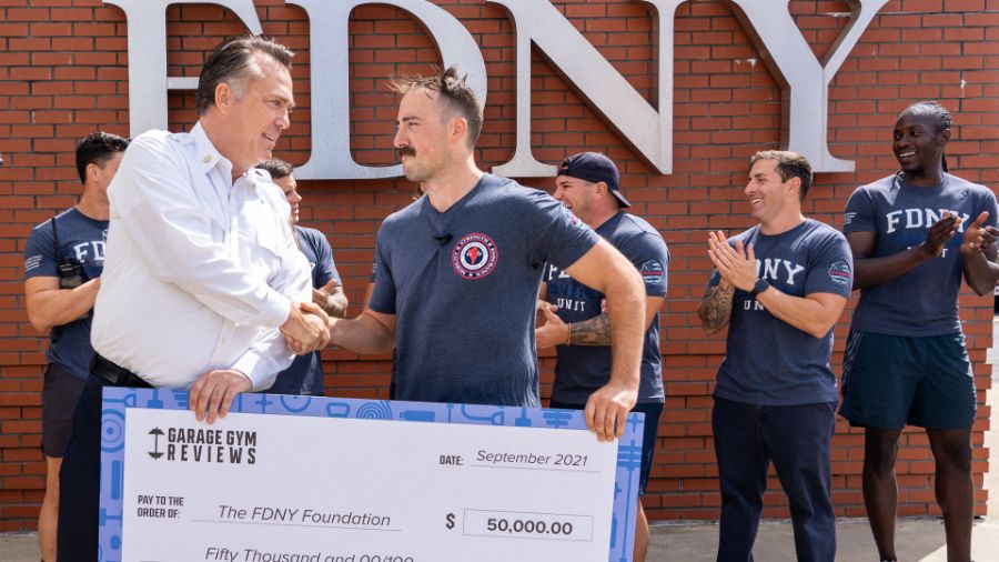 Coop presents a check for $50,000 to the FDNY