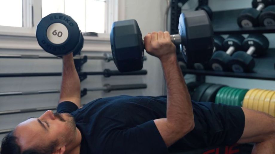 Man pressing Eleiko dumbbells