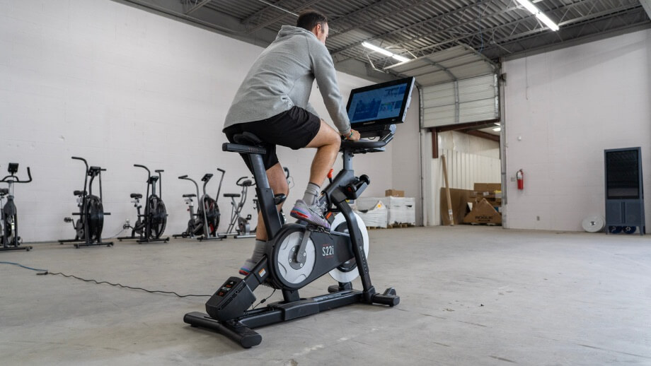 Coop riding a spin bike for a hiit bike workout
