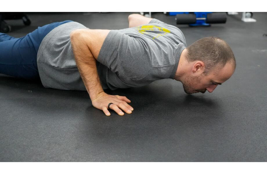 coop wearing oura wing while doing push ups