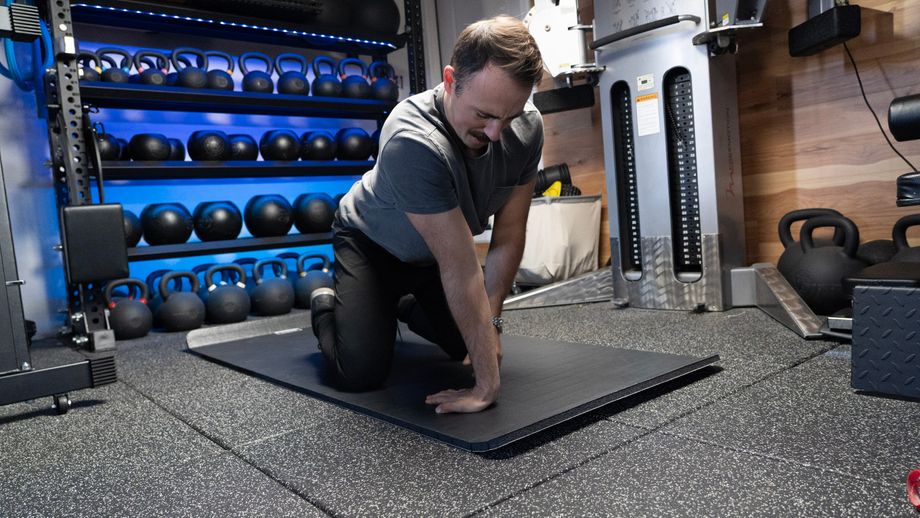 Coop in his gym doing a wrist mobility execrise