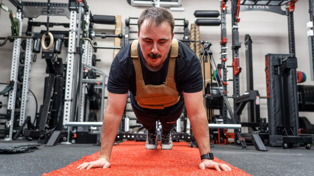 coop working out in home gym with weighted vest