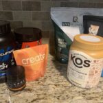An image of creatine vs protein supplements on a counter