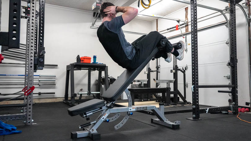 A man doing sit-ups on the REP Fitness AB-5000