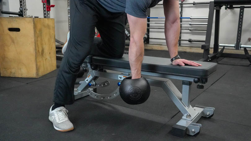 A man using the REP Fitness AB-5000 to do rows. 
