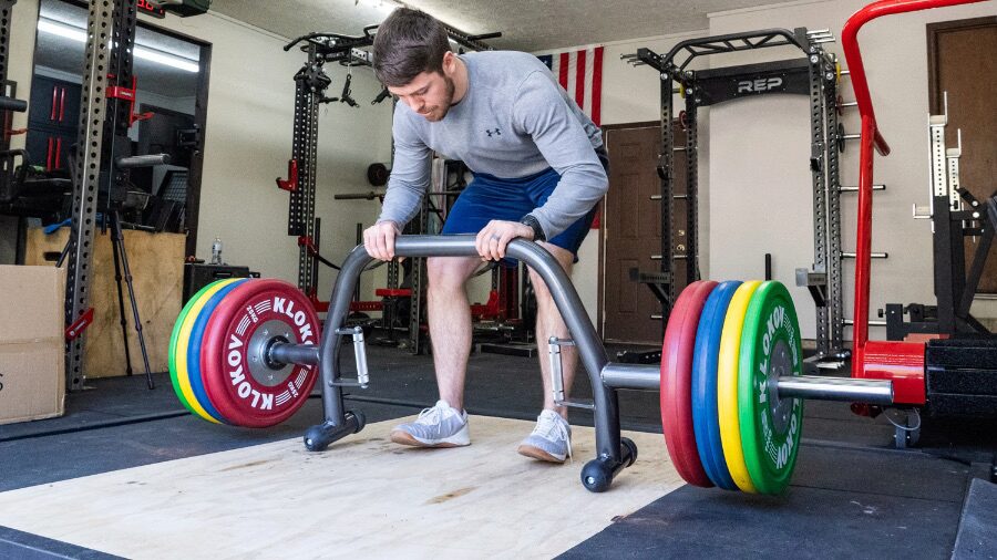 Man deadlifting on a platform