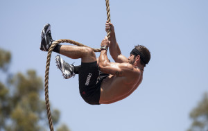 man climbing a climbing rope