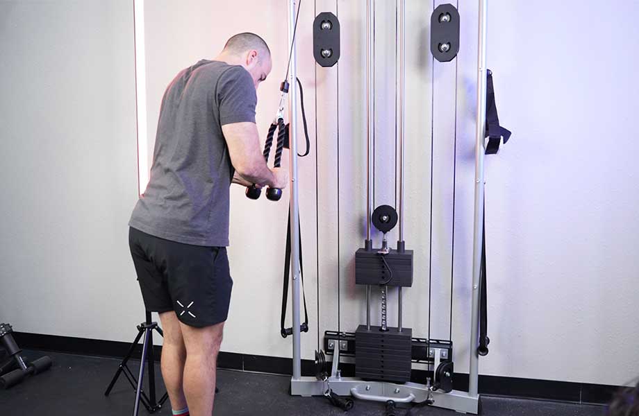 Coop doing a cable pushdown on the Torque Anker 3 functional trainer 